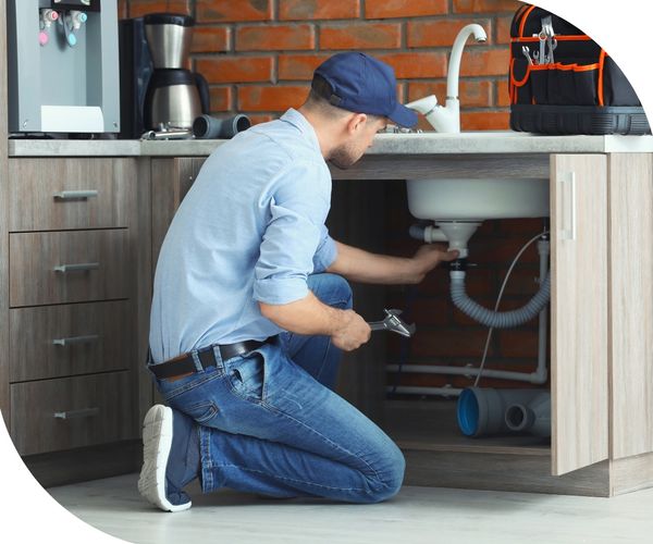 technician inspecting leaky sink