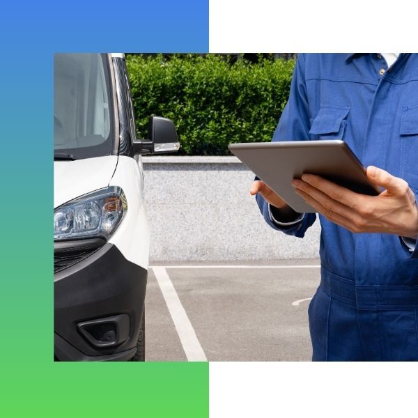 holding tablet near fleet vehicle