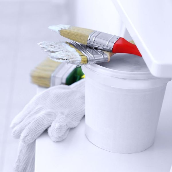 Paint brushes, gloves and a paint bucket