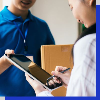 Woman signing tablet for package Woman signing tablet for package