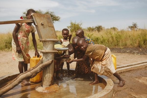 Kids getting water from well Kids getting water from well