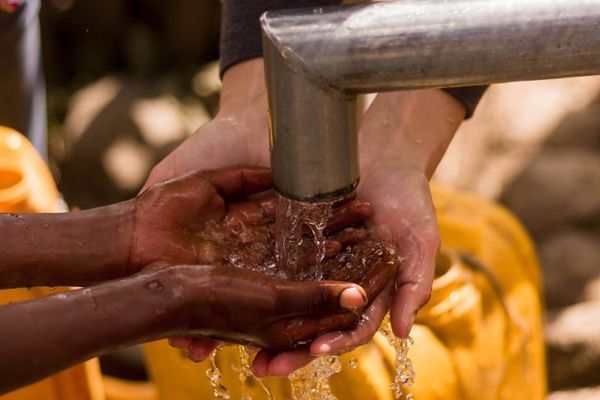 Cleaning hands in water well Cleaning hands in water well