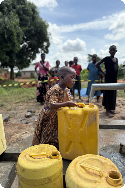 young ugandan carrying jug of water