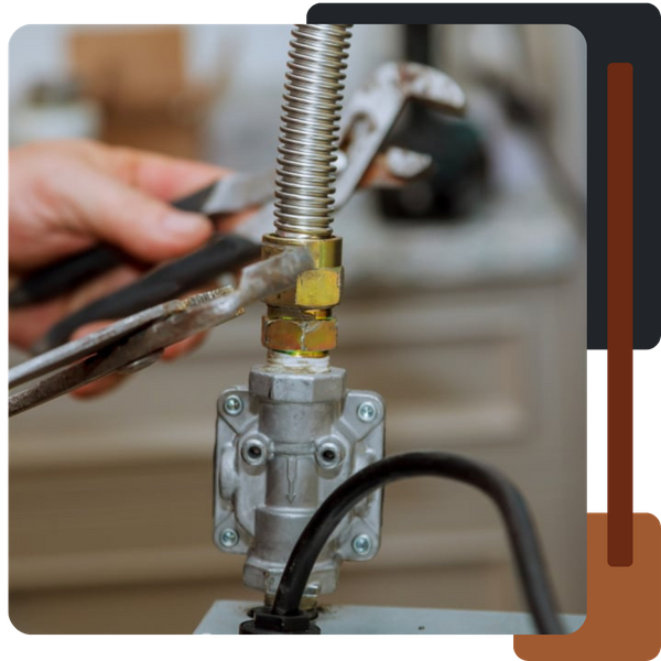 A close-up of a person using a wrench to tighten a brass connection on a flexible corrugated metal gas line attached to a regulator or valve.