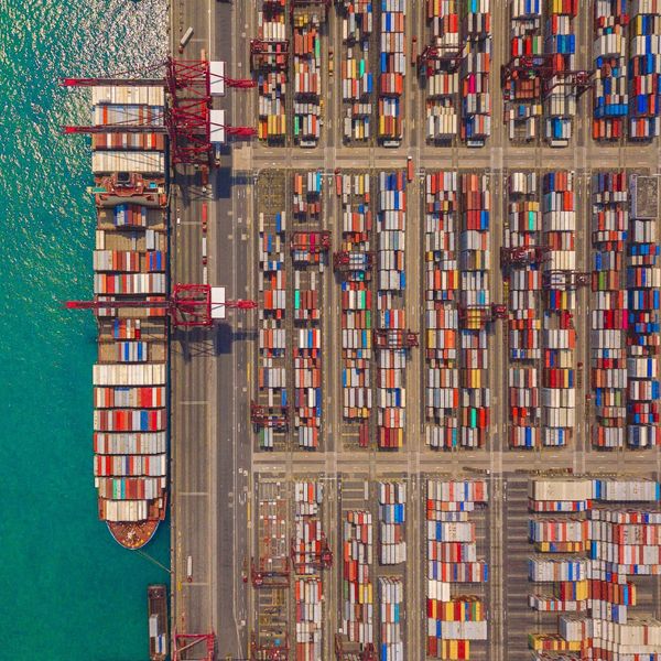 cargo ship at dock filled with cargo containers