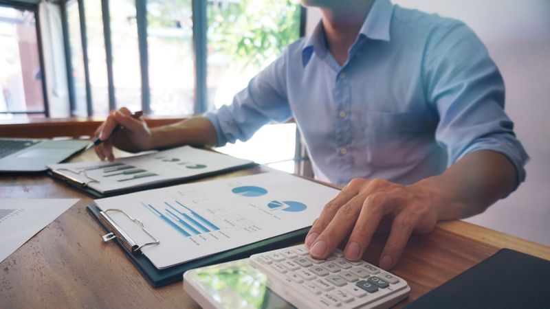 Man scanning data from graphs and charts Man scanning data from graphs and charts