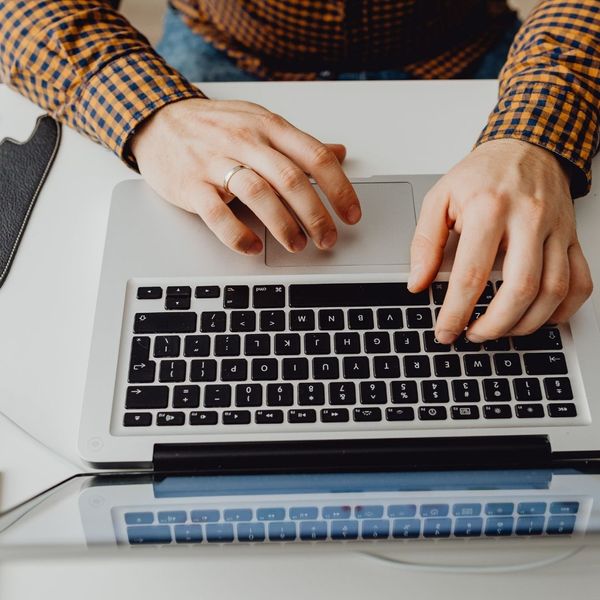 closeup of woman's hands typing on computer 