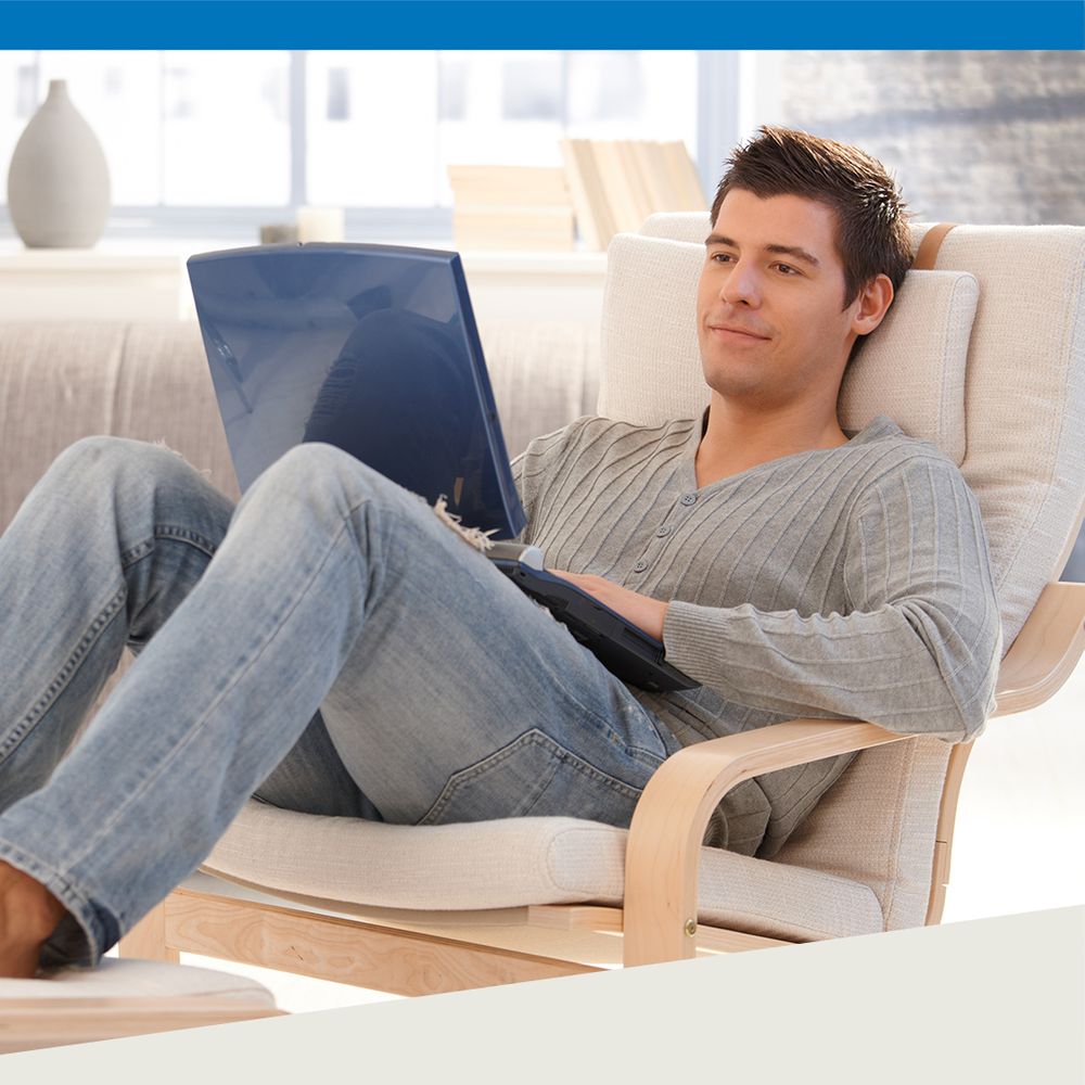 man reclining with laptop