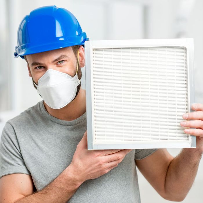 technician holding an air filter