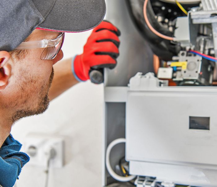 HVAC Expert Maintaining Furnace