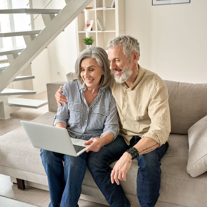Older couple searching on laptop