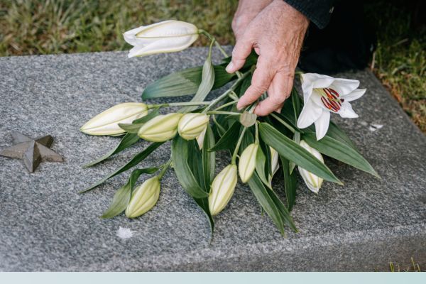 Man laying day Lilys on a headstone Del Mar3.jpg