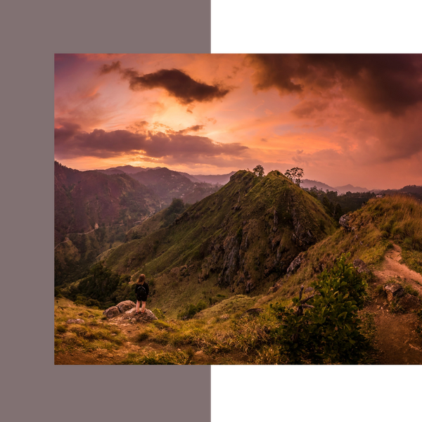 woman standing among grand mountainscape