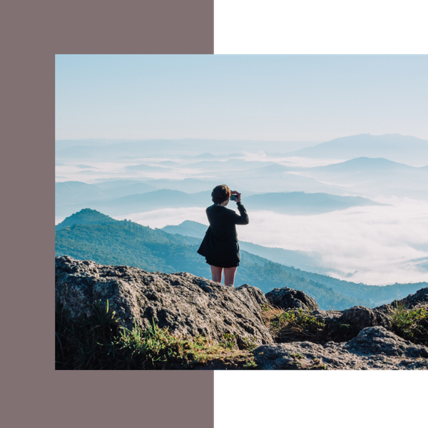 woman taking picture of scenic overlook