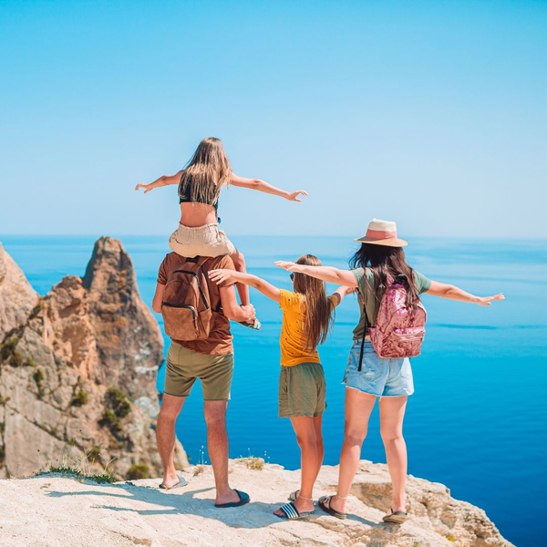 Family standing on cliff 