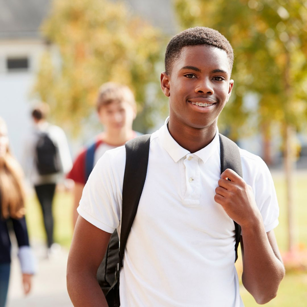 teenage student outside wearing backpack