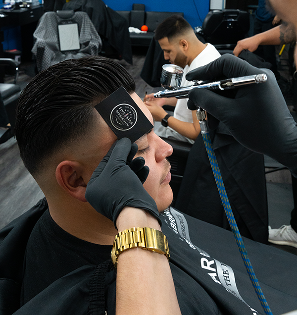 Image of a client getting his hair done