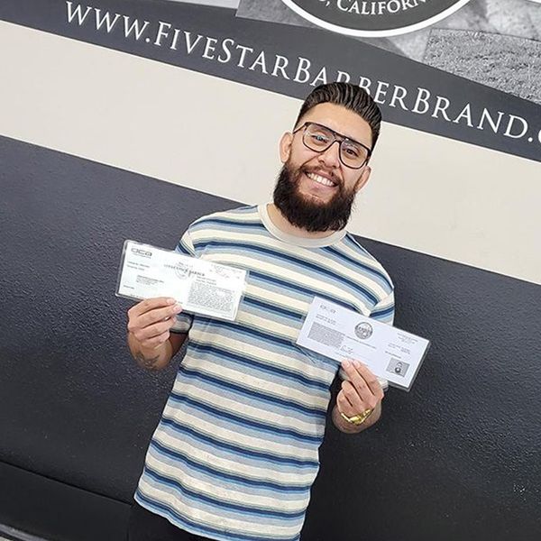 Student Holding Barber License