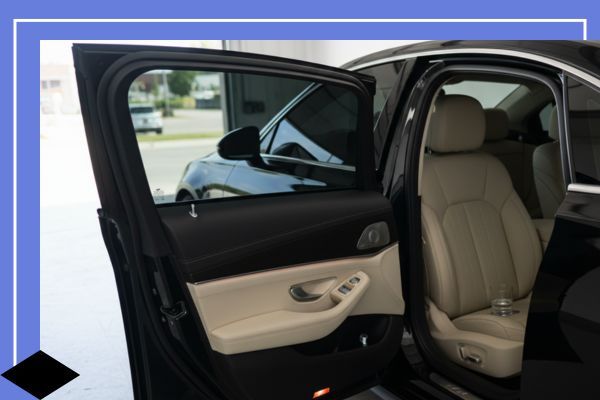 car with open door showing window tint