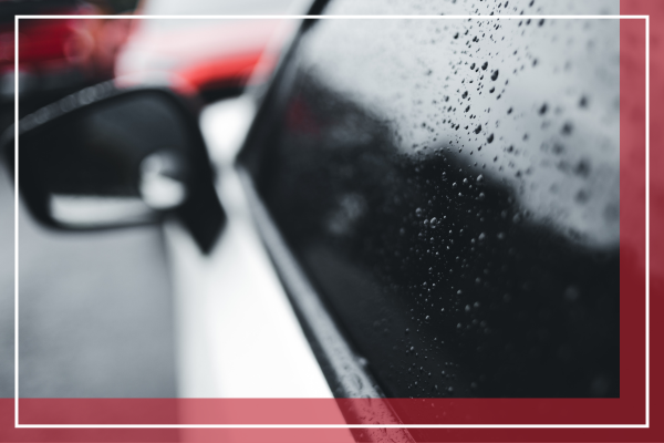 a close up of a car window with rain on the window
