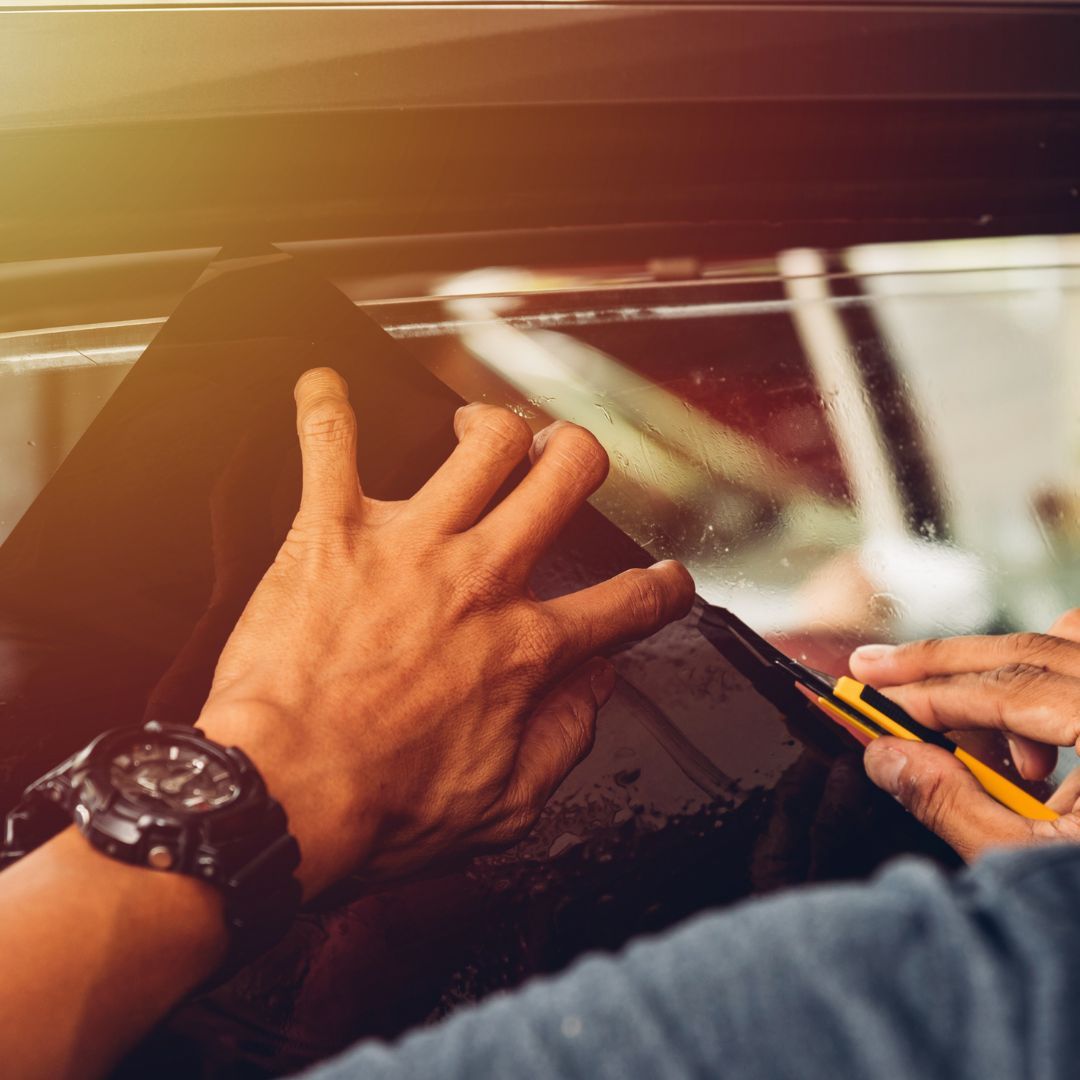 technician cutting window tint