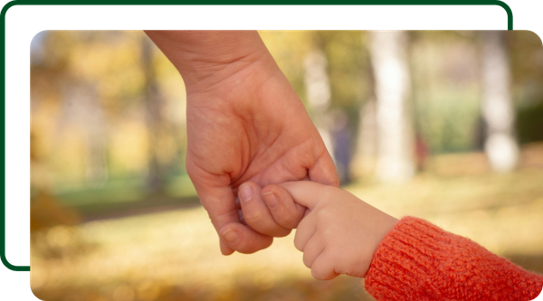 Parent holding their child's hand