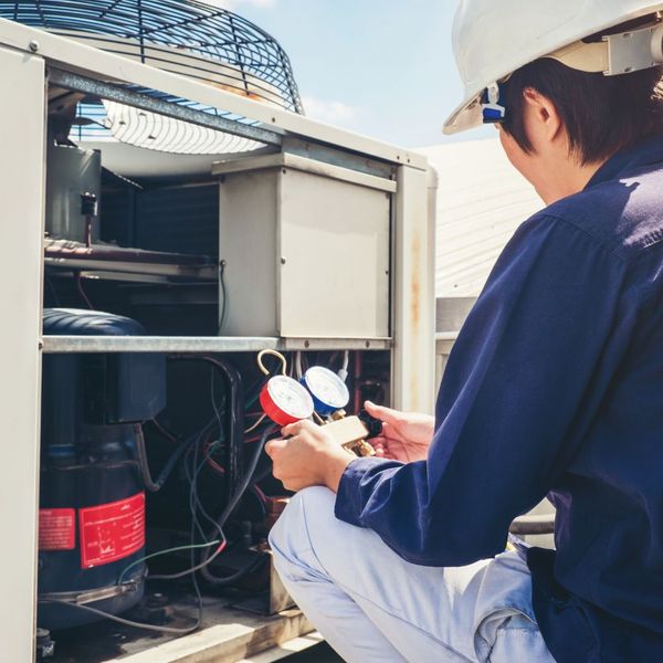 Certified HVAC Contractor repairing a unit