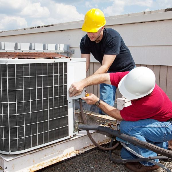 Team of contractors repairing a unit