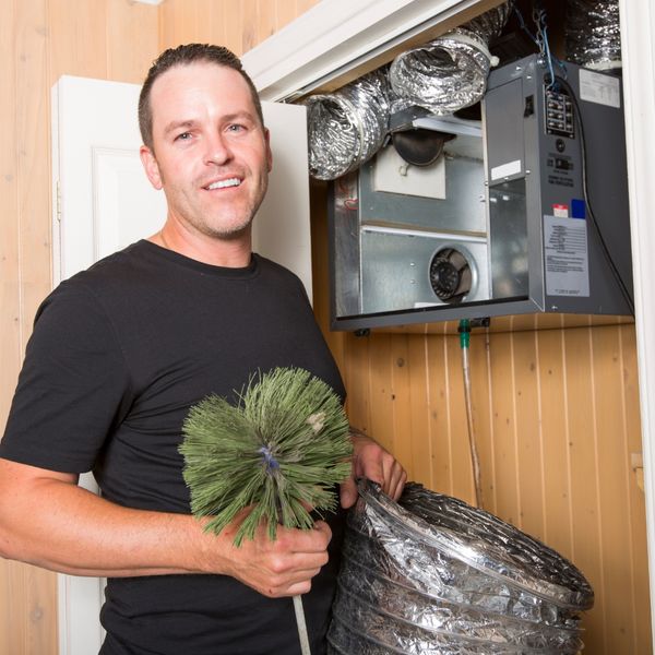 Man cleaning ducts