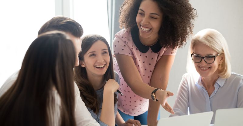 Female coworkers laughing