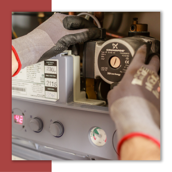 An Airvtange Heating and Cooling technicians repairing a home furnace.