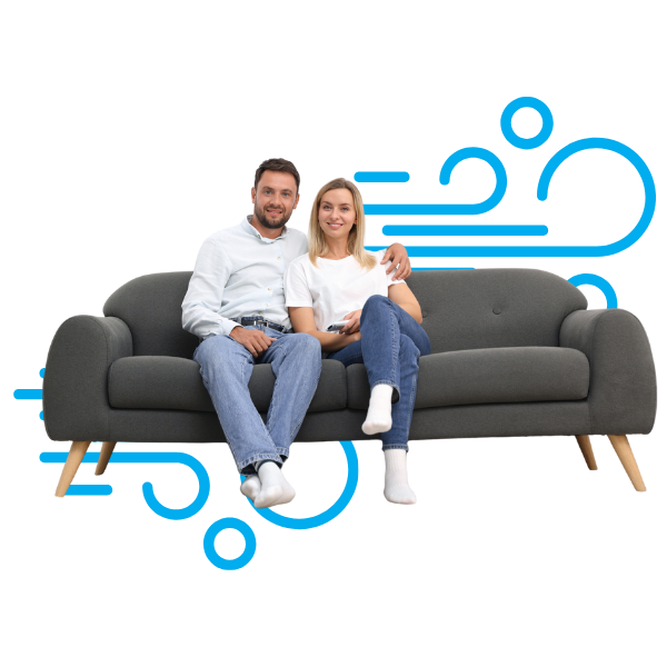 A happy couple siting comfortably on a couch, with cool air flow line designs in the background.