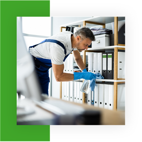 Man cleaning a bookshelf in an office