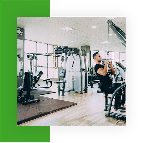 Clean gym with man using the equipment