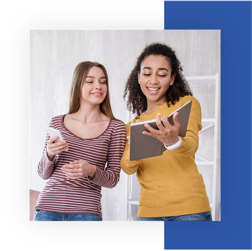 Two college girls looking at a tablet