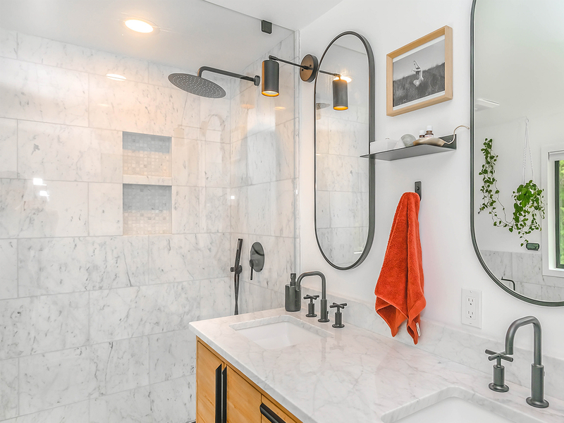 renovated bathroom with black accents and a large shower