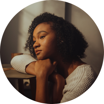 A woman looking wistfully out a window.