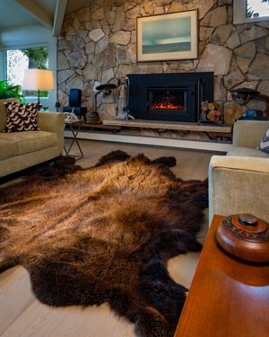 bison hide in front of fireplace