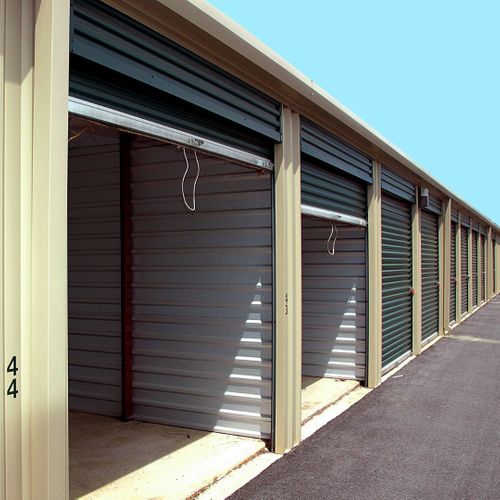 Row of partially open storage units in sunlight.