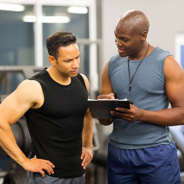 man working with personal trainer