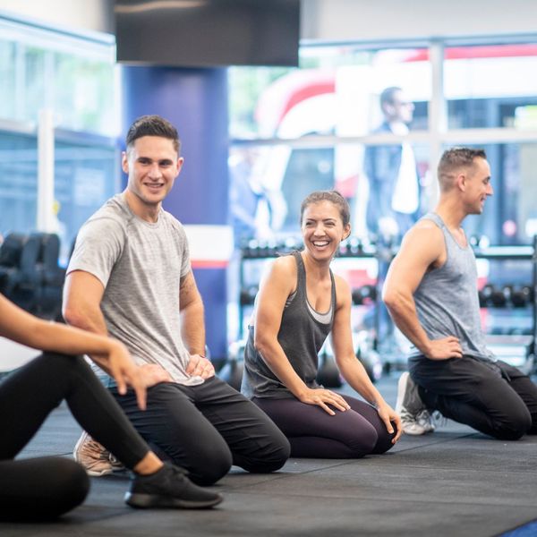 people in group fitness class laughing
