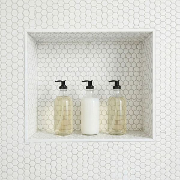 Recessed tiled shower niche with organized bottles