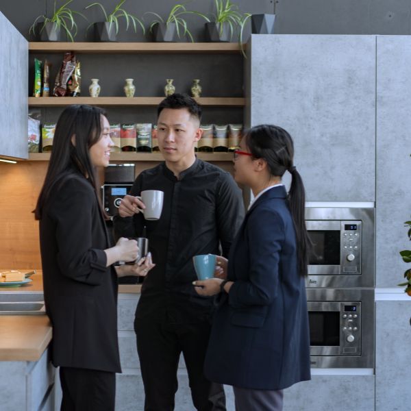 Coworkers in kitchen.