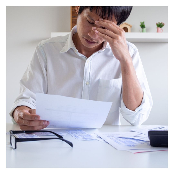 stressed man looking at business debt