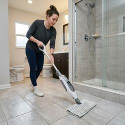 Image of a woman mopping a bathroom floor