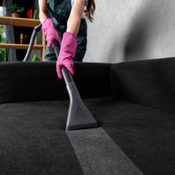 Woman vacuums couch