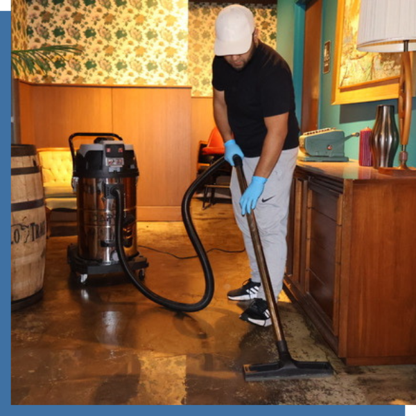 man mopping floors in restaurant