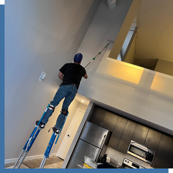 Person painting over drywall