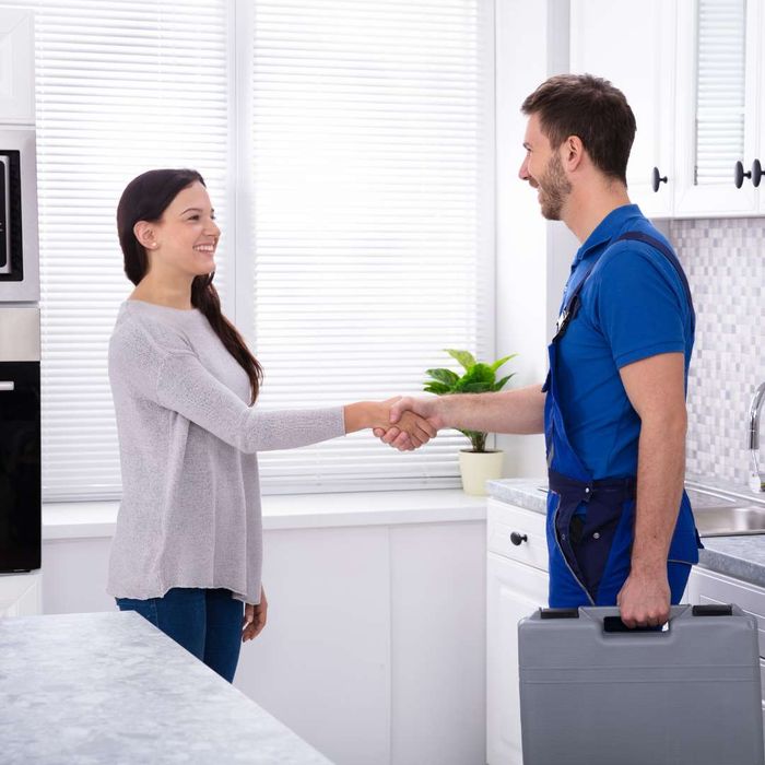 plumber shaking hands with customer