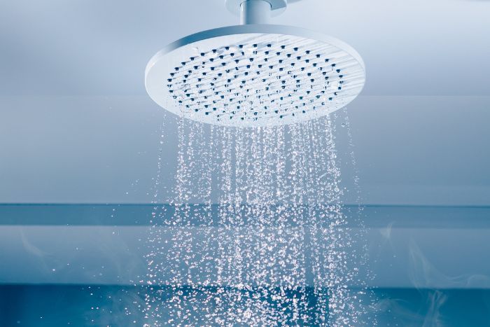 a shower head pouring hot water